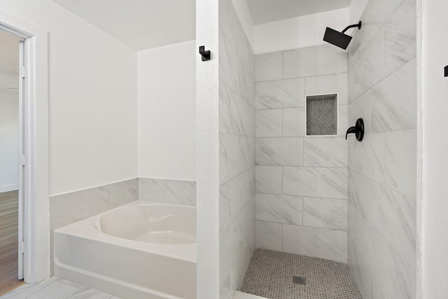 bathroom featuring a garden tub and a shower stall