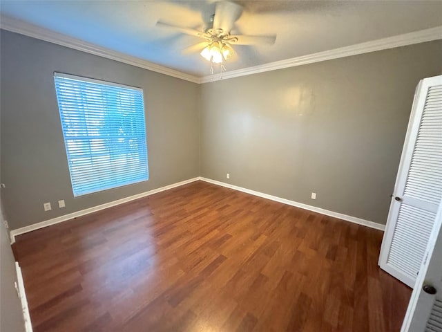 unfurnished room with baseboards, dark wood finished floors, and crown molding