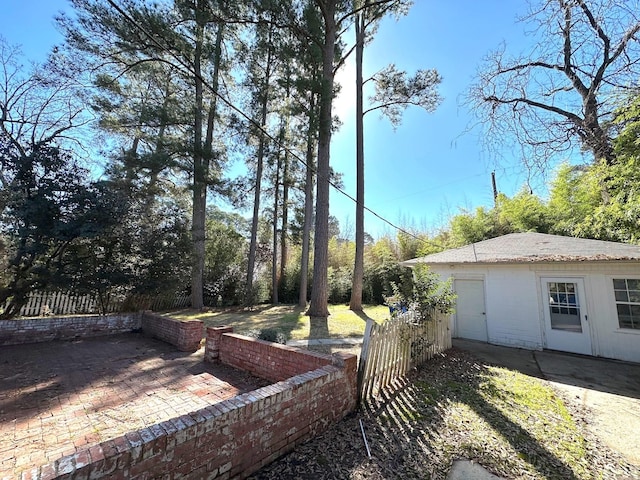 view of yard featuring fence and a patio