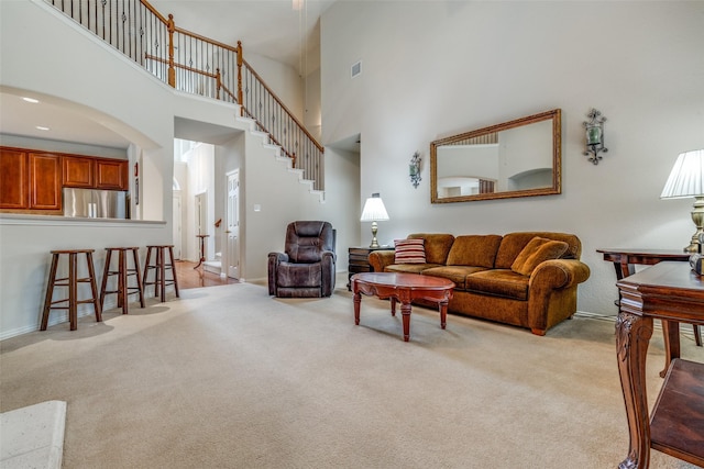 11451 La Grange Dr, Frisco, TX 75035 - living area with light carpet, a high ceiling, baseboards, and arched walkways