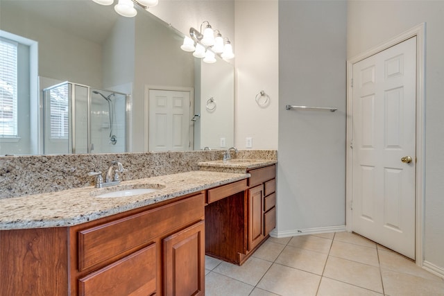 11451 La Grange Dr, Frisco, TX 75035 - bathroom with double vanity, a stall shower, tile patterned flooring, and baseboards