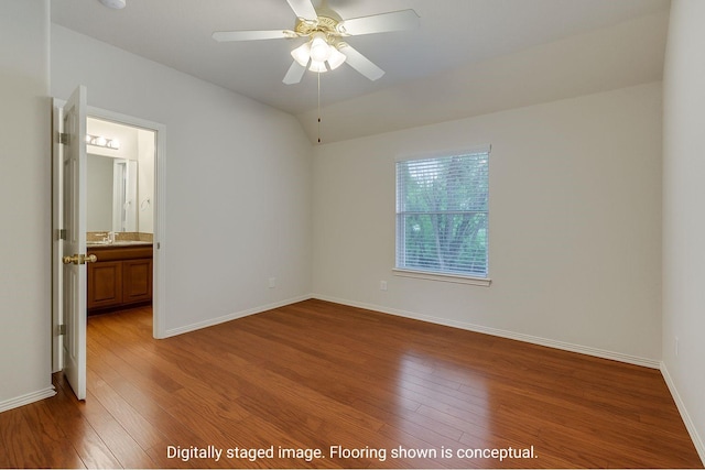 11451 La Grange Dr, Frisco, TX 75035 - unfurnished bedroom with wood finished floors, baseboards, ensuite bathroom, and vaulted ceiling