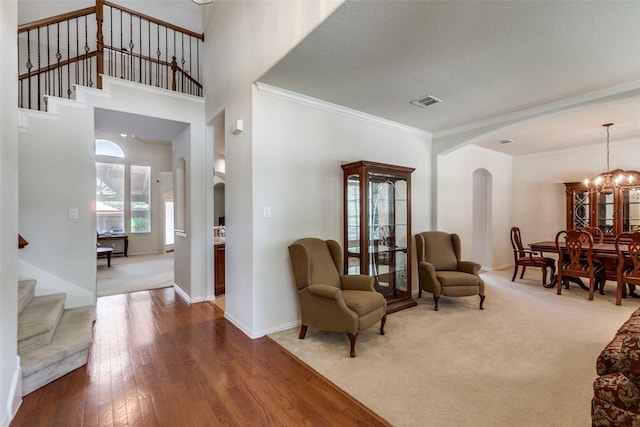 11451 La Grange Dr, Frisco, TX 75035 - living area featuring arched walkways, stairs, crown molding, wood-type flooring, and baseboards