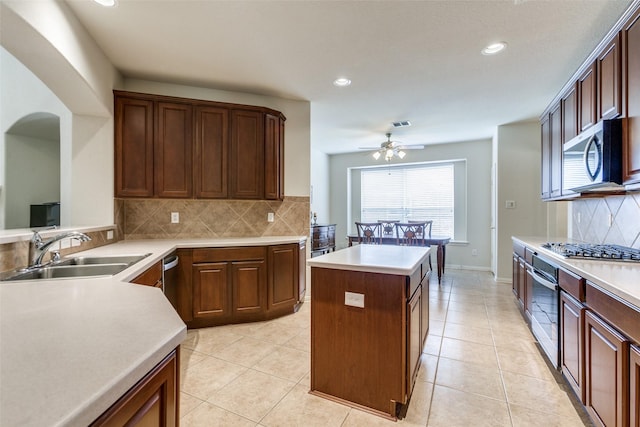 11451 La Grange Dr, Frisco, TX 75035 - kitchen featuring appliances with stainless steel finishes, a sink, ceiling fan, tasteful backsplash, and light countertops