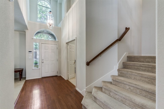 11451 La Grange Dr, Frisco, TX 75035 - foyer entrance featuring wood finished floors, a high ceiling, stairway, a chandelier, and baseboards