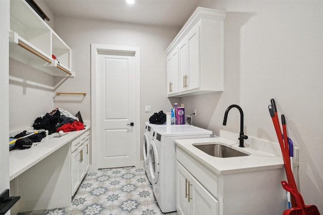 laundry area featuring cabinet space, independent washer and dryer, and a sink