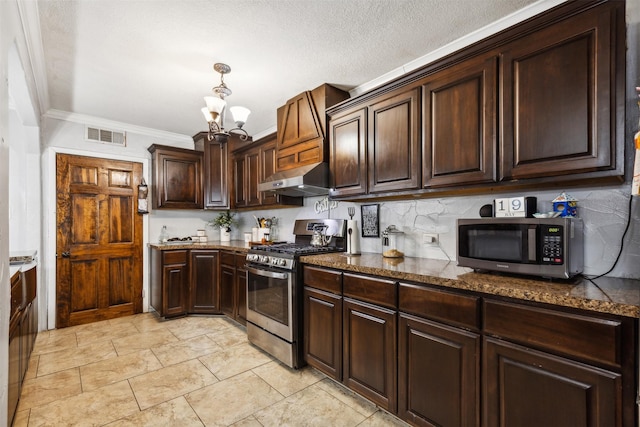 kitchen with visible vents, appliances with stainless steel finishes, dark brown cabinetry, a chandelier, and under cabinet range hood