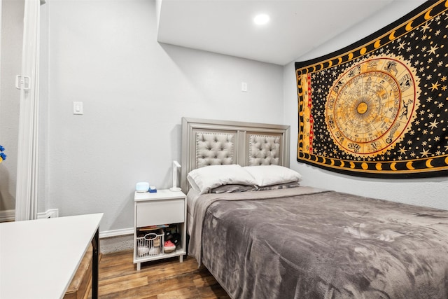 bedroom with dark wood-style flooring and baseboards