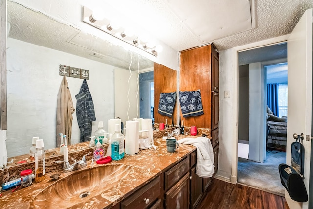 bathroom featuring vanity, a textured ceiling, and wood finished floors