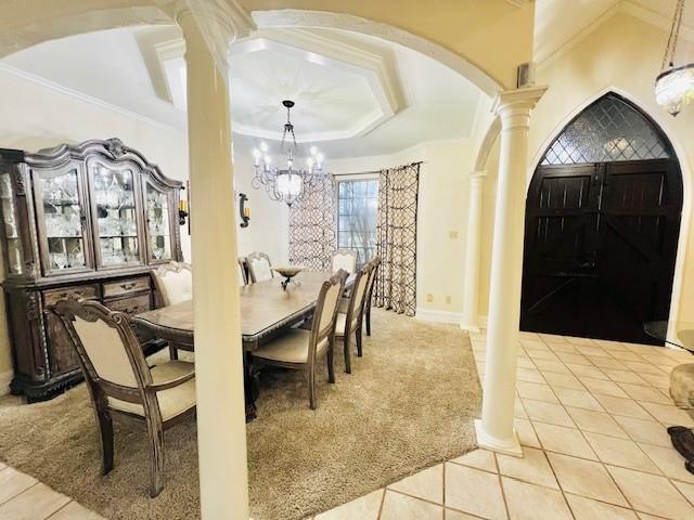 dining room featuring arched walkways, decorative columns, light tile patterned floors, an inviting chandelier, and ornamental molding