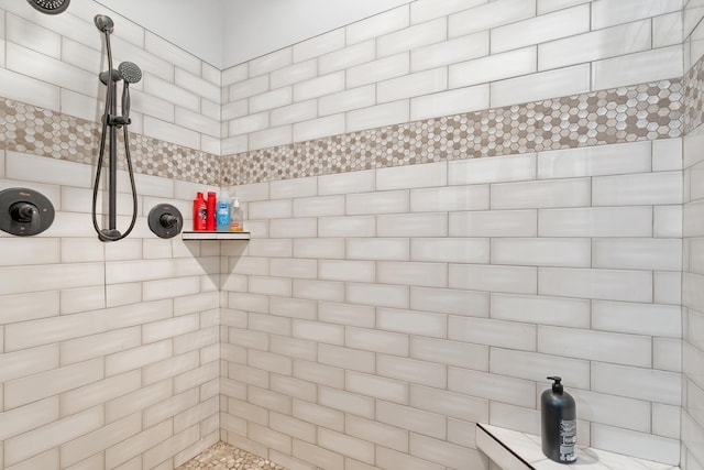 bathroom with a tile shower