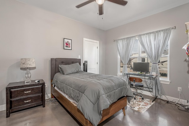 bedroom featuring ceiling fan, finished concrete floors, and baseboards