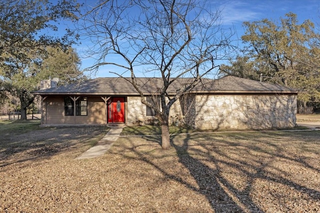 single story home featuring stone siding, a chimney, and a front lawn