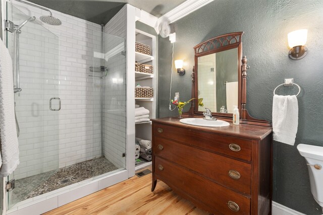 1501 Oak Shore Dr, Tool, TX 75143 - full bath with a shower stall, vanity, toilet, a textured wall, and wood finished floors