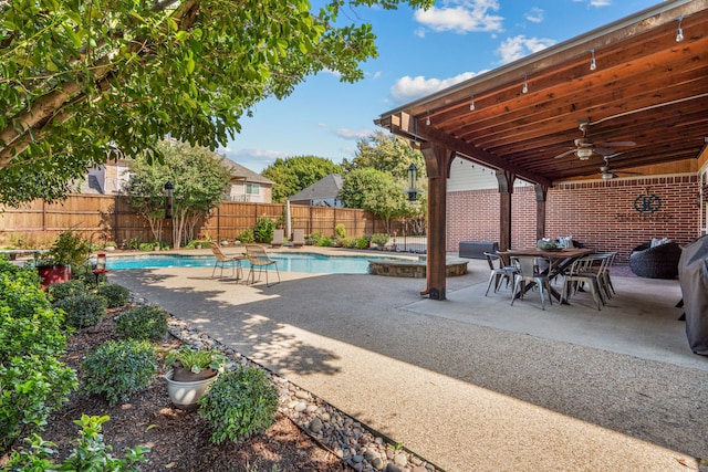 view of patio / terrace with ceiling fan, outdoor dining area, a fenced backyard, and a fenced in pool