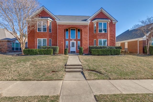 traditional home featuring brick siding and a front lawn