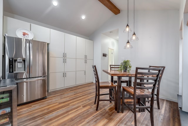 dining area featuring lofted ceiling with beams, light wood finished floors, and recessed lighting