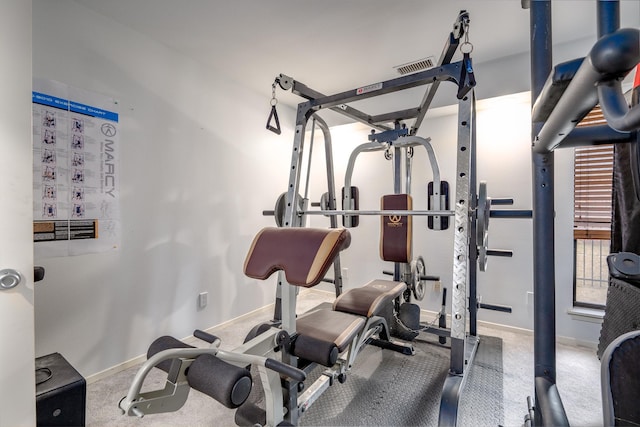 exercise room featuring carpet flooring, visible vents, and baseboards