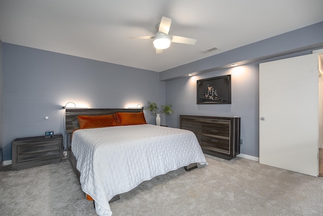 bedroom featuring a ceiling fan, light colored carpet, visible vents, and baseboards