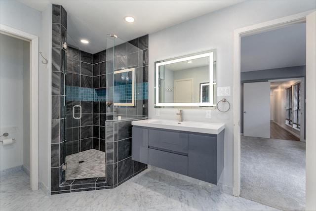 bathroom with marble finish floor, a shower stall, vanity, and recessed lighting