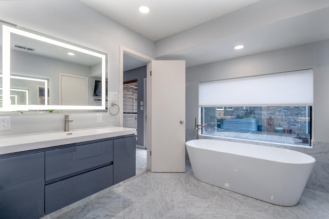 bathroom with recessed lighting, vanity, visible vents, marble finish floor, and a soaking tub