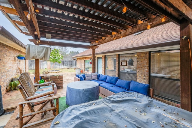 view of patio featuring fence, outdoor dining area, a wooden deck, outdoor lounge area, and a pergola