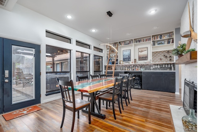 dining room with wood finished floors, visible vents, and recessed lighting