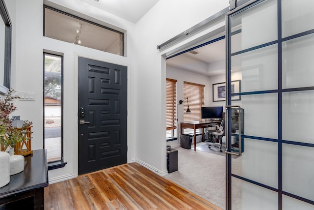 entryway featuring baseboards and wood finished floors