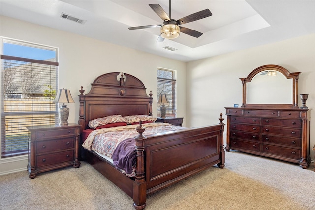 bedroom featuring light carpet, multiple windows, and visible vents