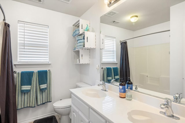 full bathroom featuring toilet, shower / bath combo, visible vents, and a sink