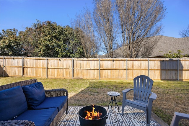 view of yard featuring an outdoor living space with a fire pit and fence