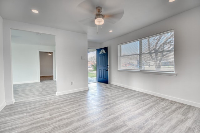 unfurnished room featuring recessed lighting, wood finished floors, a ceiling fan, and baseboards