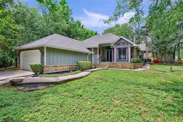 view of front of house featuring board and batten siding, a front yard, a garage, stone siding, and driveway