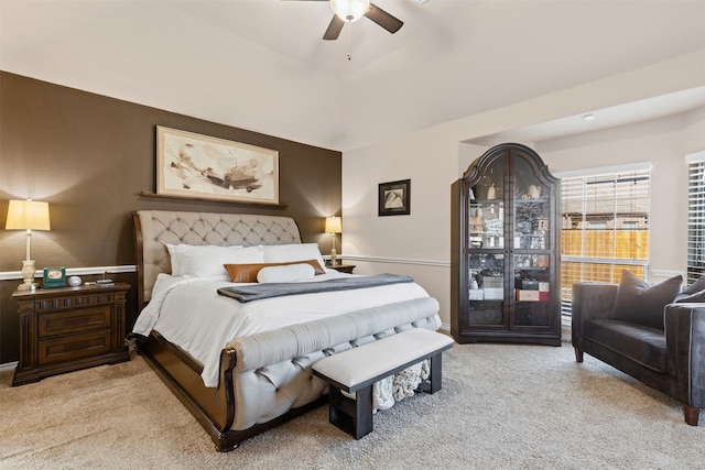 bedroom with ceiling fan and light colored carpet