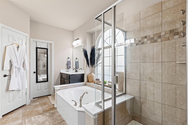 bathroom with a garden tub, a stall shower, and vanity