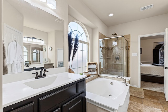 bathroom with a garden tub, visible vents, a stall shower, vanity, and ensuite bath