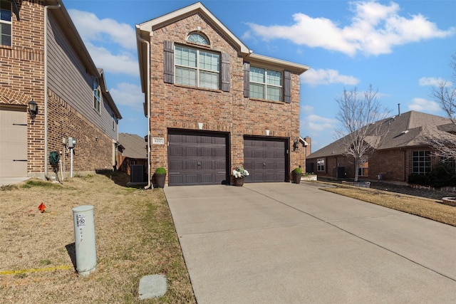 traditional-style house with a garage, central AC, brick siding, concrete driveway, and a front yard