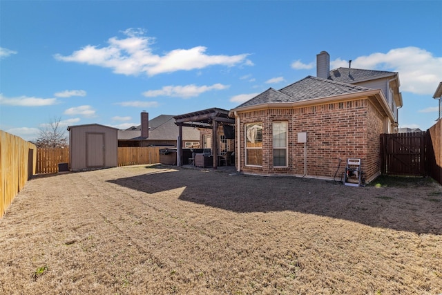 back of house featuring an outbuilding, brick siding, a storage unit, a pergola, and a fenced backyard