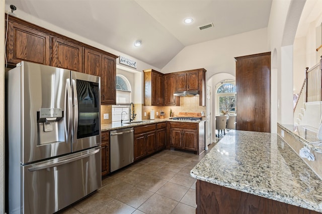 kitchen featuring light stone countertops, plenty of natural light, visible vents, and stainless steel appliances