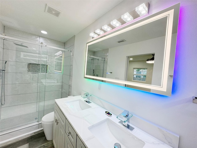 full bath featuring toilet, a sink, and visible vents