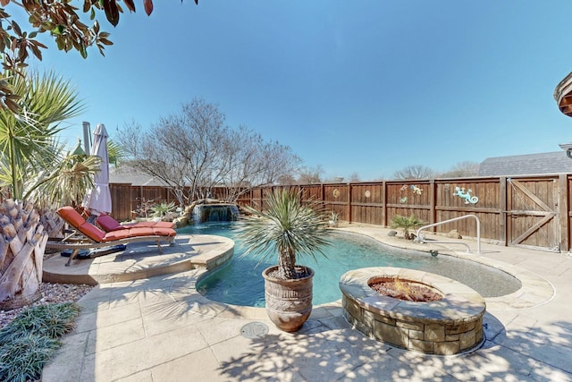 view of swimming pool with a fire pit, a patio, a fenced backyard, and a fenced in pool