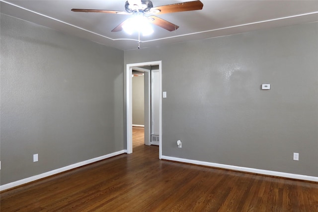 empty room with a ceiling fan, baseboards, and wood finished floors