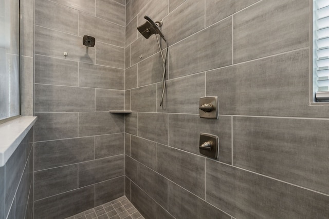 bathroom with a tile shower