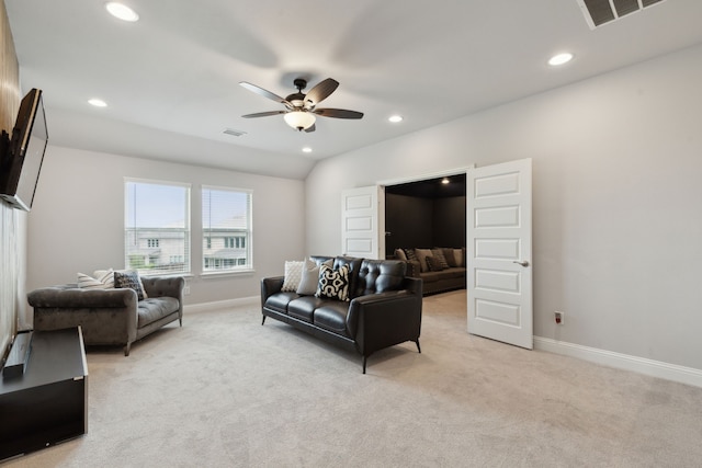 living room with recessed lighting, light carpet, visible vents, and baseboards