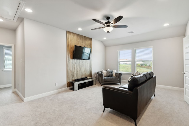 living room with attic access, light colored carpet, visible vents, and plenty of natural light