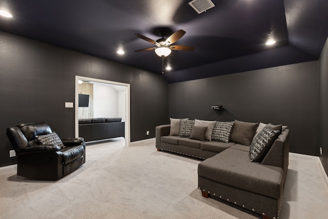 home theater with lofted ceiling, visible vents, carpet flooring, ceiling fan, and baseboards