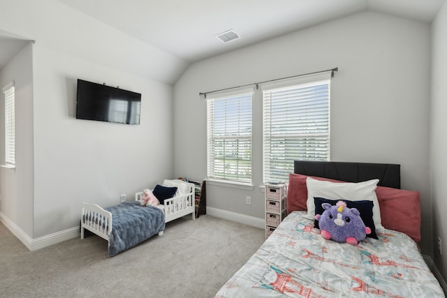 carpeted bedroom with lofted ceiling, visible vents, and baseboards