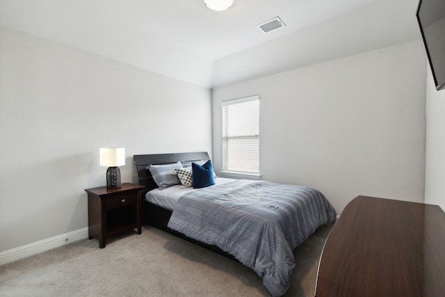 bedroom featuring light carpet, lofted ceiling, visible vents, and baseboards