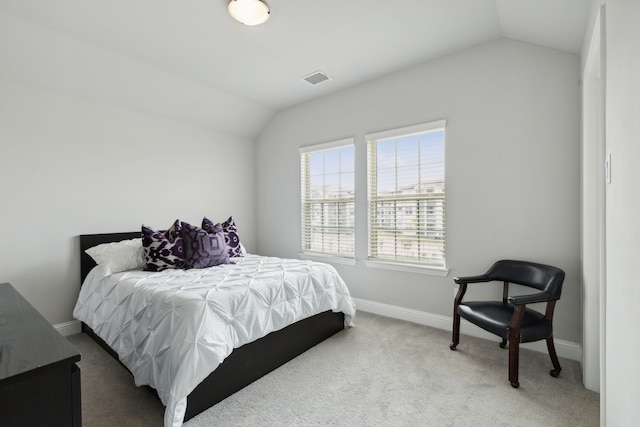 bedroom with lofted ceiling, baseboards, visible vents, and carpet floors