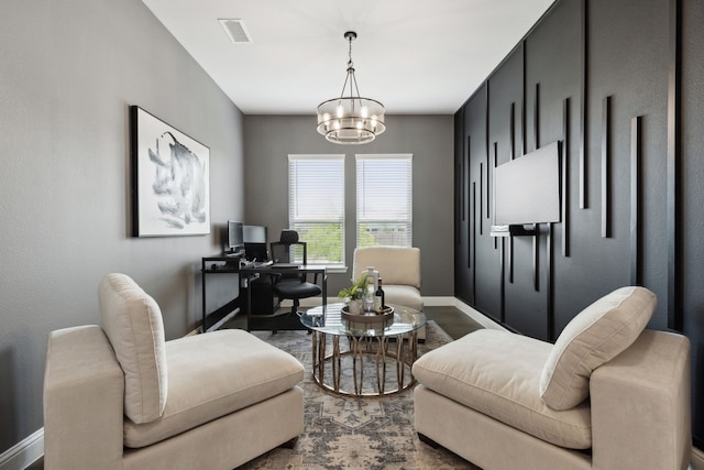 living area featuring baseboards, dark wood-style flooring, visible vents, and an inviting chandelier